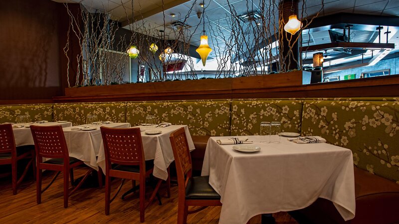 Dining room banquette with four tables.