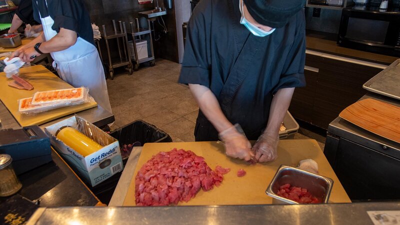 Sushi chef's preparing sushi.